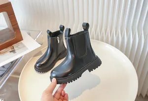 Detailed view of children's black British style Martin boots with side zipper and durable anti-slip sole