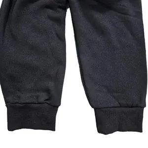 Close-up macro detail of elastic ribbed cuffs on black men's casual fleece sweatpants