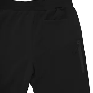 Close-up detail of mens black fleece joggers with a back pocket and side zipper pocket