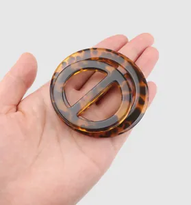 Macro view of the elegant tortoiseshell resin decorative buckle for high-end clothing