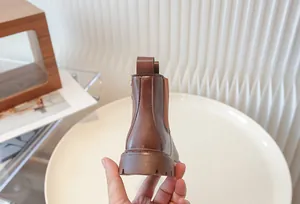 High-quality detailed back view of children's vintage brown leather Chelsea boots for kids