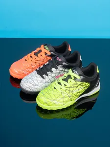 Detail view of colorful kids soccer shoes with durable synthetic leather and turf cleats