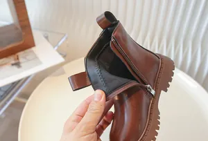 Detailed view of child's brown Martin boot showing interior lining and side zipper