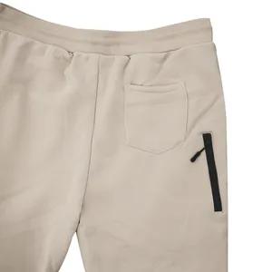 Detailed macro shot of men's fleece sweatpants showing rear pocket and side zip closure