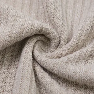 Close-up detail of soft beige ribbed knit fabric for men's long sleeve sweater