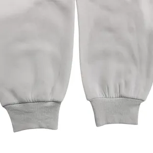 Close-up of ribbed cuffs on gray fleece sweatpants showing fabric texture and detail.