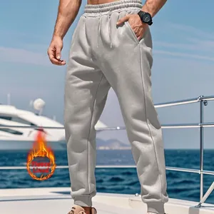 Outdoor lifestyle view of grey fleece-lined men's jogger sweatpants on a boat.