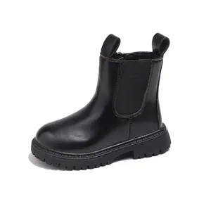 Kids' black British style Chelsea Martin boots with thick lug sole on white background.