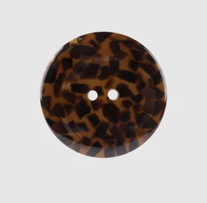 Macro view of a premium round resin button with brown tortoiseshell pattern texture