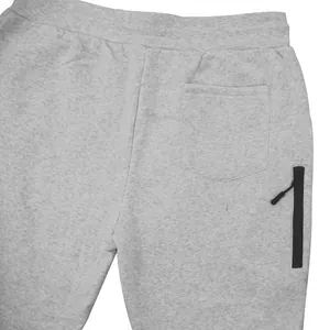 Detail view of light grey fleece sweatpants showing back pocket and side zipper