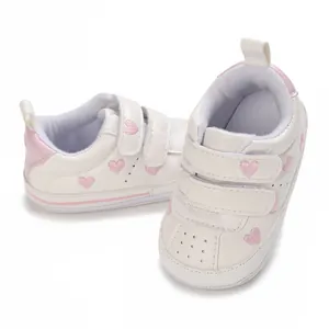 Comfortable white baby sneakers featuring cute pink heart embroidery and easy Velcro straps.