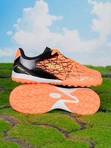 Detailed view of children's orange turf soccer cleats with durable studded soles
