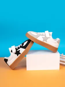 Detail view of boys' casual board shoes featuring star pattern and hook-and-loop straps