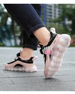 Close-up of pink girls' sneakers featuring rotating button and transparent bubble sole