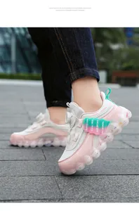 Detail view of pink girls mesh sneakers featuring rotary buckle and thick bubble sole