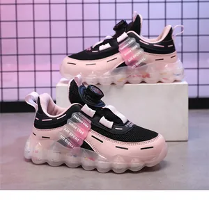 Detailed view of pink and black kids' sneakers with rotary buckle and mesh fabric