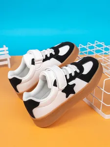 Kids stylish black and white sneakers with star detail, gum sole and velcro strap