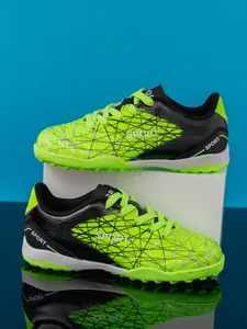 Detailed side view of boys' vibrant fluorescent green turf soccer shoes for soccer training