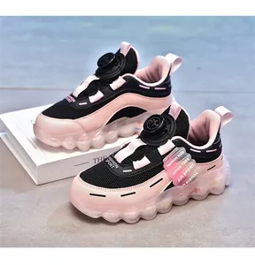 Trendy pink and black girls' sports shoes with breathable mesh and rotary buckle system.