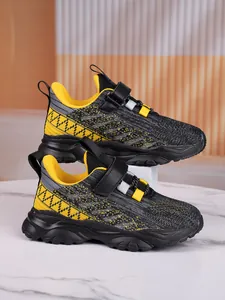 Side view of breathable mesh kids sneakers in yellow and grey color