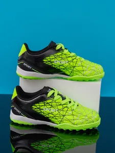 Side view of lime green and black kids' turf soccer shoes with 'SPORT' text