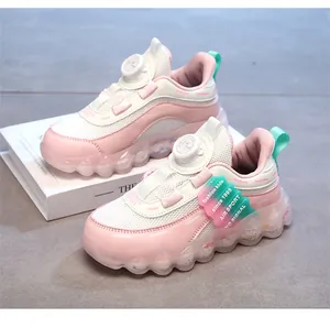 Detailed view of girls' pink sneakers featuring breathable mesh and rotary buckle closure.