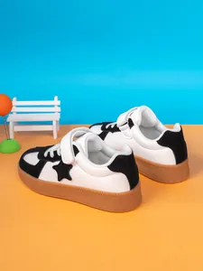 Detailed view of 2024 autumn boys' white low-top sneakers with black star and gum sole