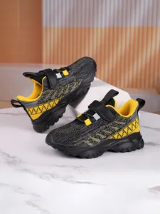 Close-up of kids breathable mesh sneakers in black and yellow with velcro strap