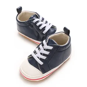 Close-up detail van marineblauwe baby wandelschoenen met witte veters en PU-zool