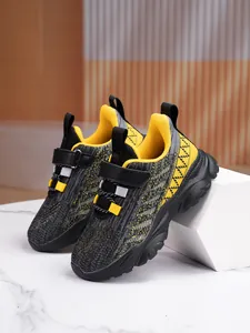 Macro view of breathable mesh sneakers for boys and girls in vibrant black and yellow