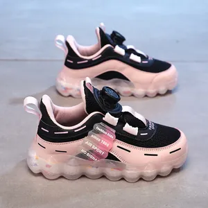 Girls' pink sports shoes with rotating buckle and breathable mesh, ages 6-12.