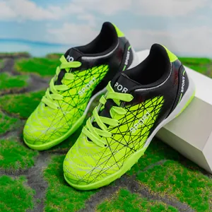 Breathable boys' turf soccer shoes for kids training in vibrant neon green and black