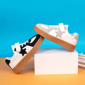 Kids low-top casual sneakers featuring a star design and convenient velcro straps.