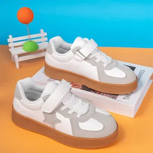 Boys' casual white and grey leather sneakers with star detail and thick brown rubber sole
