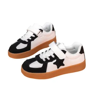 Boys' black and white synthetic leather low-top sneakers with star design and gum sole
