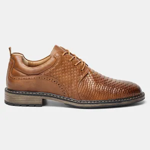 Side view of brown men's dress shoes with unique scale pattern texture and brogue details