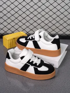 Zapatillas deportivas en blanco y negro para niños con suela de goma y velcro