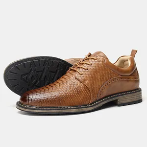 Detail view of brown men's business shoes featuring scale texture and brogue accents.