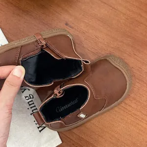 Detail showing the soft inner lining and side zipper of these brown baby Martin boots.
