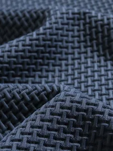 Detailed macro shot showcasing the premium interlocking texture of athletic polo shirt fabric