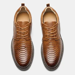 Top-down view of men's brown dress shoes featuring unique embossed snakeskin texture.