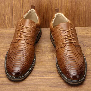 Macro view of brown men's business leather shoes with premium snakeskin pattern texture