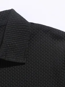 Detailed close-up showing the unique brick texture of a black men's polo shirt collar