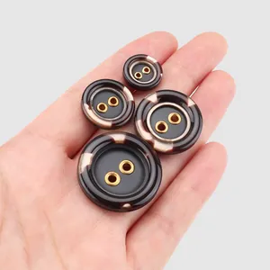 Premium tortoiseshell resin buttons with gold metal grommets shown in various sizes