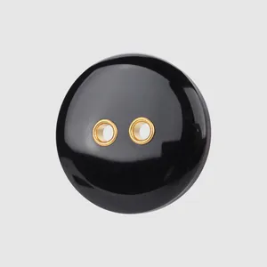 High-end glossy black resin decorative button with elegant gold metal double eyelets