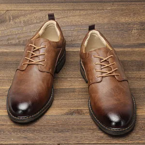 Close-up macro view showing texture of brown leather men's business dress shoes.