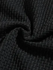 Close-up macro shot of breathable black waffle texture fabric for athletic men's polo shirt