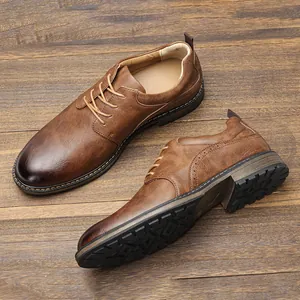 Detail view of brown men's business casual dress shoes showing leather texture and sole.