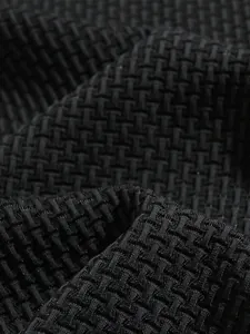 Detailed macro shot of breathable black woven texture on athletic knit polo shirt fabric