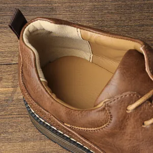 Close-up detail of the soft padded interior and heel lining of brown leather shoes